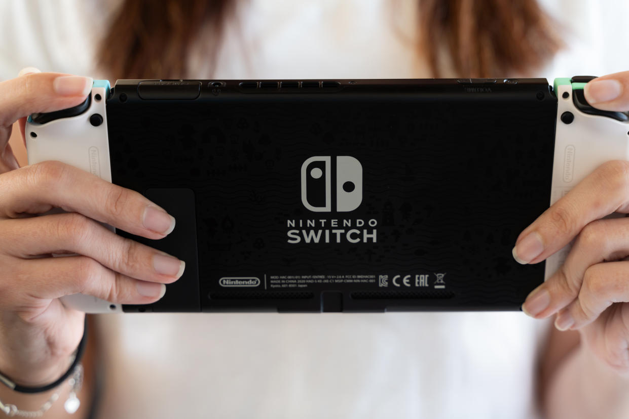 young girl playing at home with Nintendo Switch special edition - selective focus