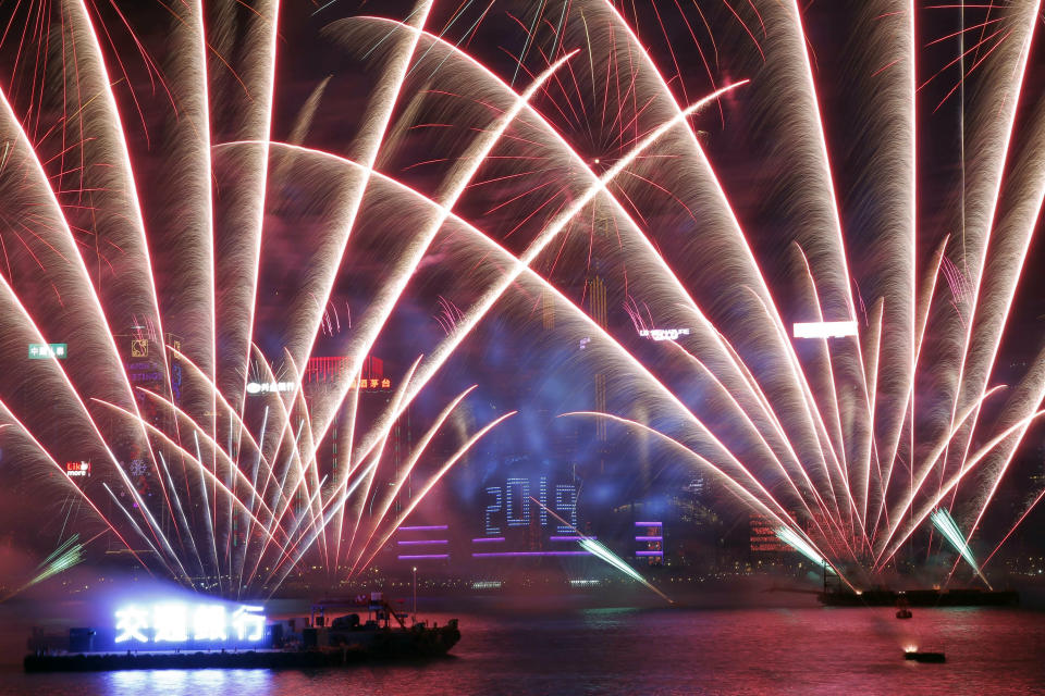 Fireworks explode over the Victoria Harbor during New Year's Eve to celebrate the start of year 2019 in Hong Kong, Tuesday, Jan. 1, 2019. (AP Photo/Kin Cheung)