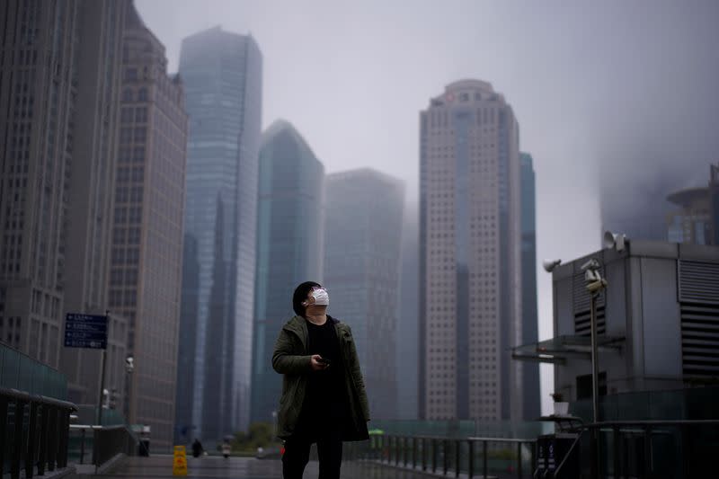 A man wearing a protective face mask is seen following an outbreak of coronavirus (COVID-19), at Lujiazui financial district in Shanghai