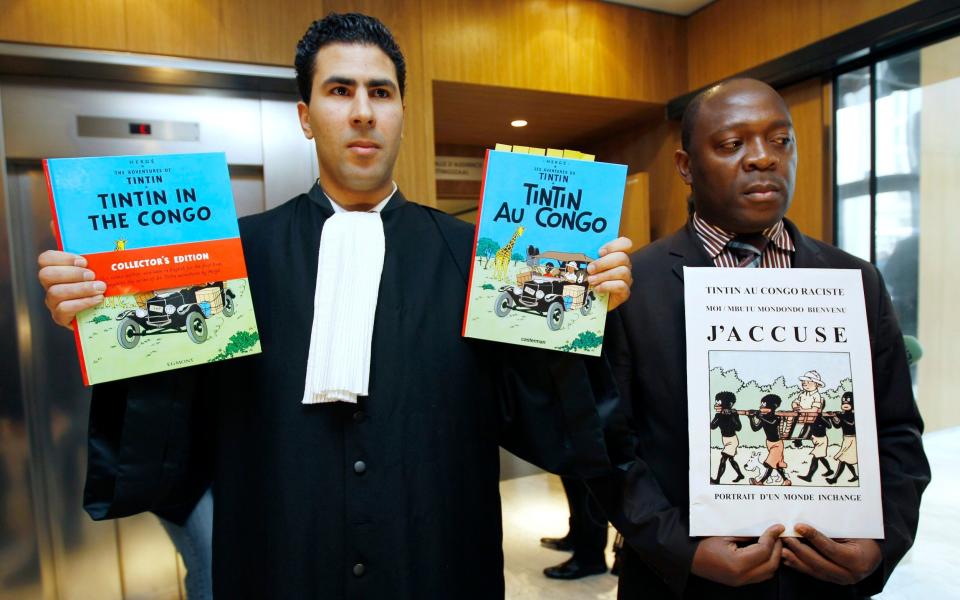 Bienvenu Mbutu Mondondo (r, with his lawyer) campaigned in 2010 to ban the book in Belgium - Reuters