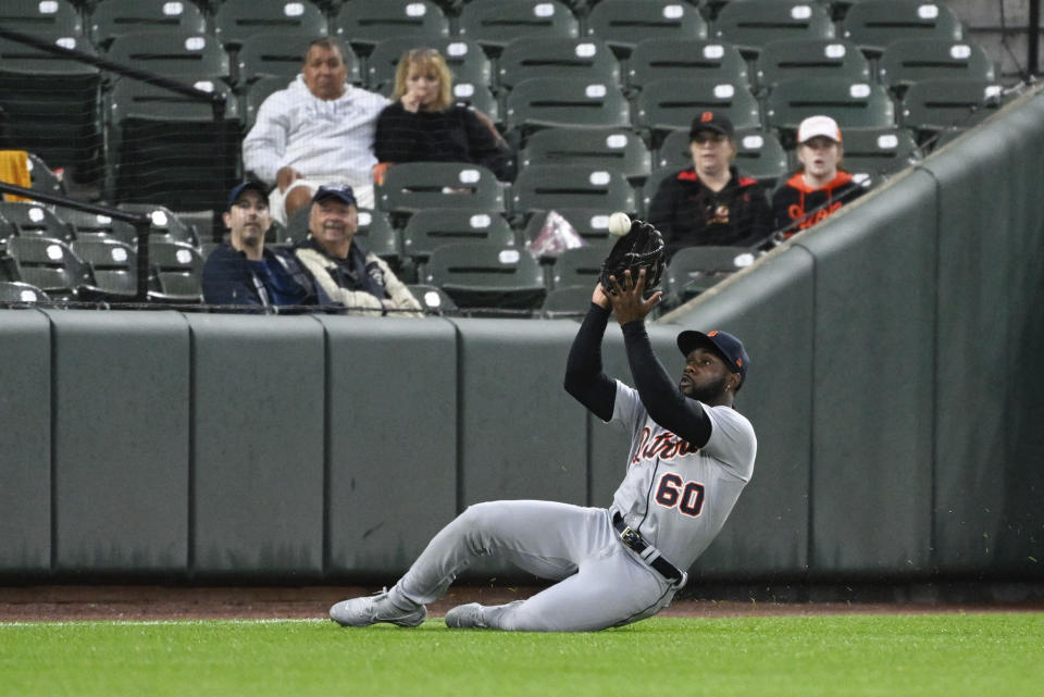 Detroit Tigers left fielder Akil Baddoo (60) makes a sliding catch on a ball hit by Baltimore Orioles' Anthony Santander during the first inning of a baseball game Saturday, April 22, 2023, in Baltimore. (AP Photo/Terrance Williams)