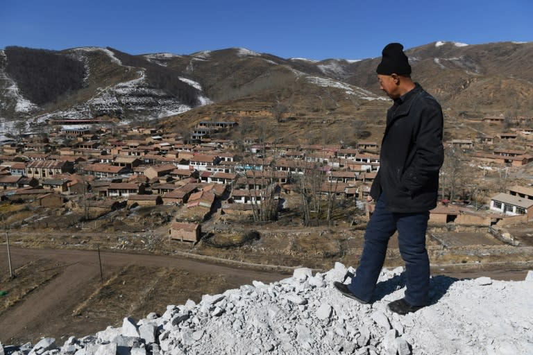 Rsident Ying Gui looks over a village that is to be demolished to make way for the 2002 Winter Games