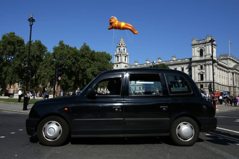 A balloon depicting London Mayor Sadiq Khan in a yellow bikini floats over London as critics hit back for a similar stunt against US president Donald Trump
