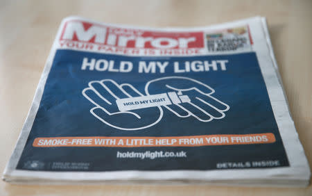 The front of a four page wraparound advertisement by Philip Morris calling on people to quit smoking for 30 days is seen on the front page of the daily Mirror in London, Britain, October 22, 2018. REUTERS/Andrew Winning