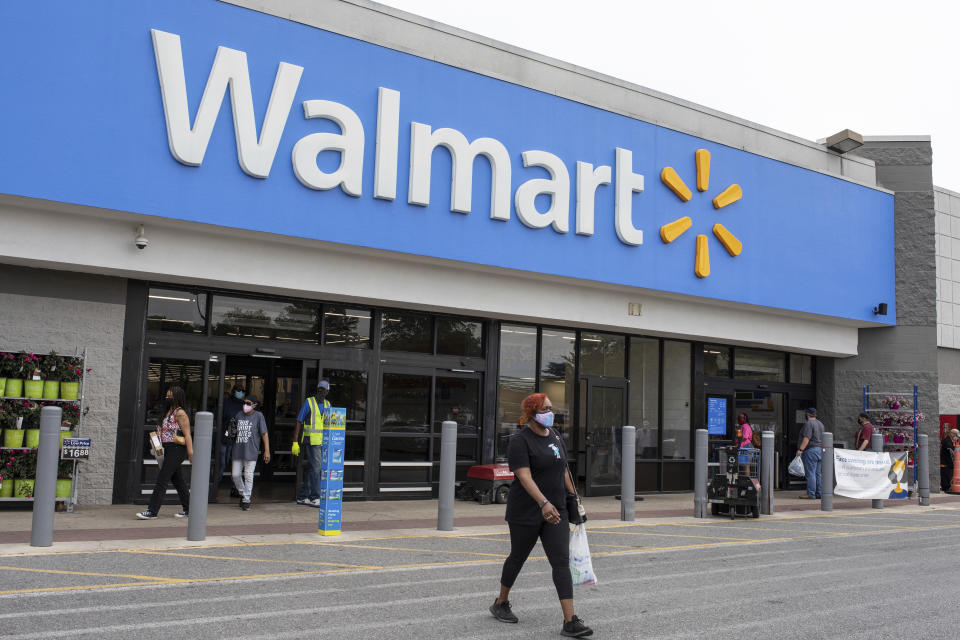 In this image for the Howard Center for Investigative Journalism at the University of Maryland's Philip Merrill College of Journalism, shoppers walk out of a Walmart store in Waldorf, Md., May 7, 2021. The Occupational Safety and Health Administration has not cited the nation's largest retailer despite employee complaints, illnesses and deaths at Walmart facilities across the country. The company says there is no proof that employees contracted COVID-19 at work. (Brittany N. Gaddy/University of Maryland via AP)