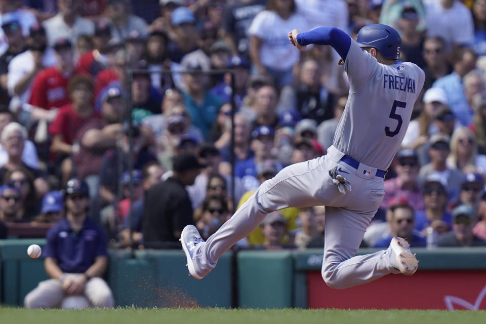 Los Angeles Dodgers' Freddie Freeman advances to third on a fly out to center by Amed Rosario in the fifth inning of a baseball game against the Boston Red Sox, Sunday, Aug. 27, 2023, in Boston. (AP Photo/Steven Senne)