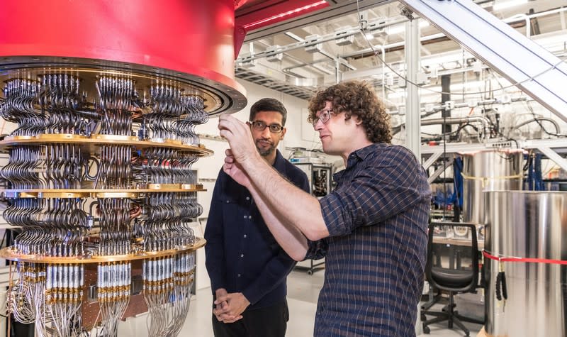 A handout picture shows Pichai and Sank with one of Google's Quantum Computers in the Santa Barbara lab