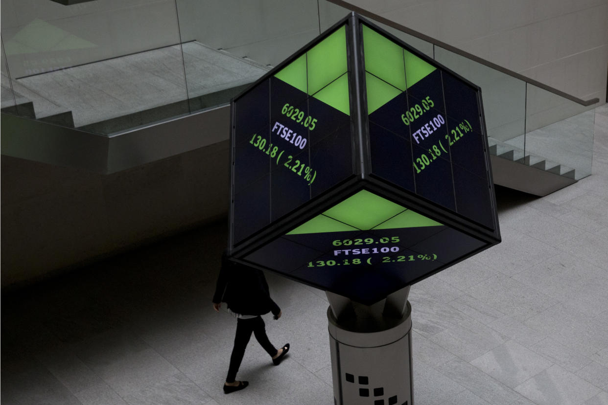 FTSE market information is displayed on a cube-shaped display inside the London Stock Exchange in the City of London, Tuesday, Aug. 25, 2015.  Chinese stocks fell Tuesday for a fourth day, hitting an eight-month low amid signs Beijing was no longer buying shares to stem a price slide, and Japanese stocks also dropped. But other Asian and European markets bounced back from a day of heavy losses.  (AP Photo/Matt Dunham)