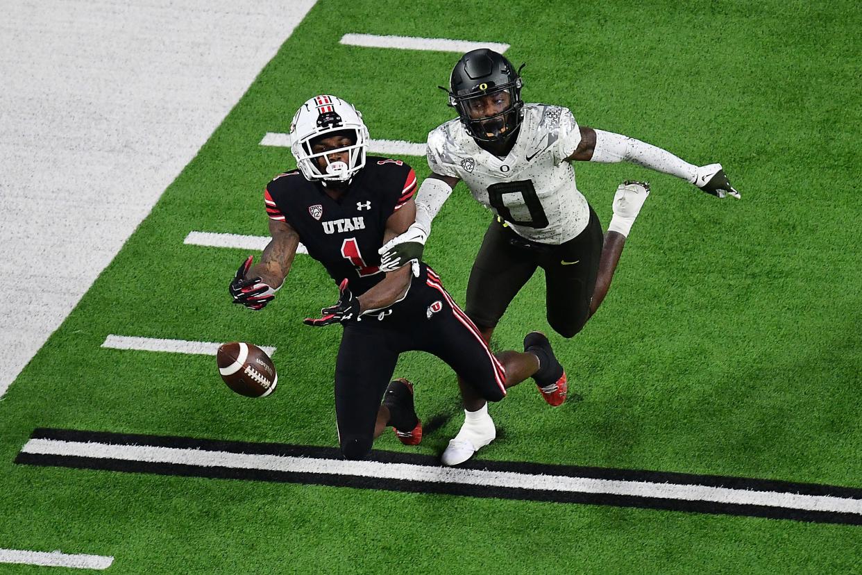 Oregon Ducks cornerback DJ James (0) defends against Utah Utes wide receiver Theo Howard (1) during the second half in the 2021 Pac-12 Championship Game at Allegiant Stadium.