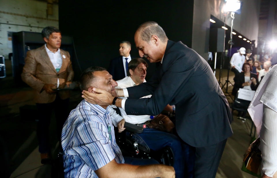 <p>Deputy Prime Minister of Turkey Numan Kurtulmus (R) meets with Bosnians during a ceremony, to mark the 22nd anniversary of the 1995 Srebrenica massacre, in an old battery factory, which was used as a headquarter by UN soldiers, in Potocari village of Srebrenica, Bosnia and Herzegovina on July 11, 2017. (Photo: Ahmet Bolat/Anadolu Agency/Getty Images) </p>