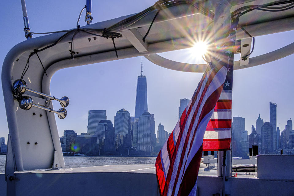 FILE - The lower Manhattan skyline of New York City is framed in the rigging of a passenger ferry approaching the city, Friday morning, April 22, 2022. Starting this week, job-seekers in New York City will have access to a key piece of information: how much money they can expect to earn for an advertised opening.(AP Photo/J. David Ake)