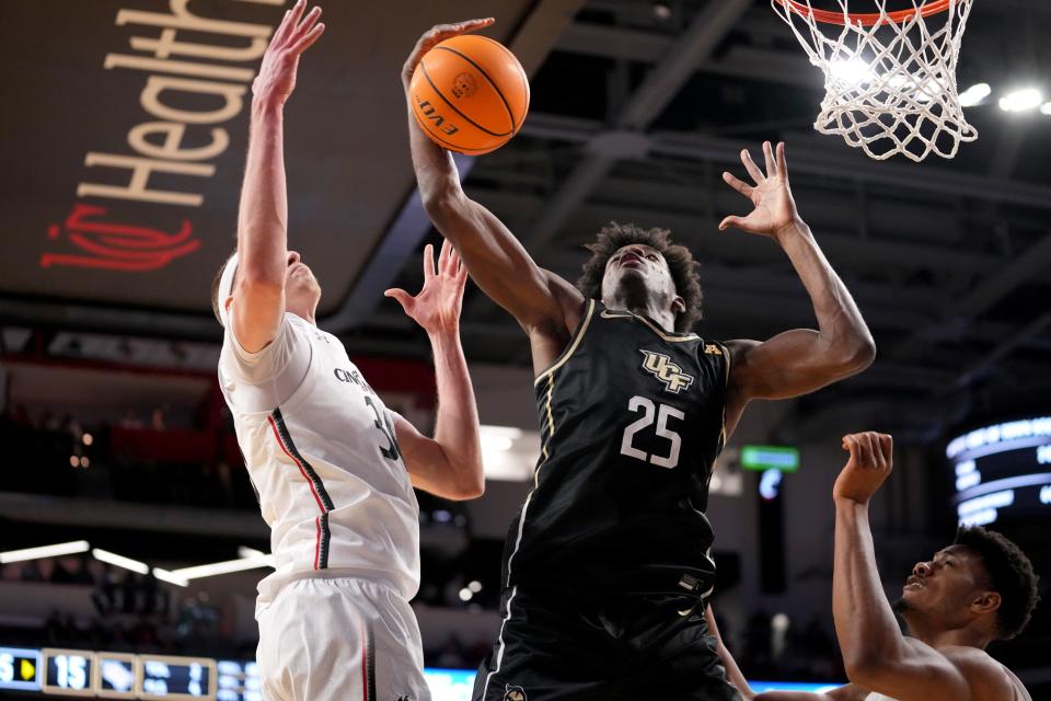 UCF Knights forward Taylor Hendricks (25) rebounds the ball against Cincinnati Bearcats forward Viktor Lakhin (30) in the first half of a college basketball game between the UCF Knights and the Cincinnati Bearcats, Saturday, Feb. 4. UC won the first matchup 74-63.