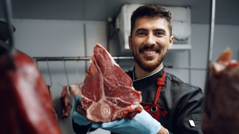 butcher showing off a steak