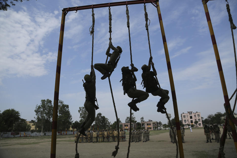 Special police officer recruits who completed nearly three months physical training demonstrate their skills at Kathua in Indian-controlled Kashmir, Saturday, June 5, 2021. Special police officers are lower-ranked police officials who are mainly recruited for intelligence gathering and counterinsurgency operations. In recent years, the force has assisted in border areas as well because of local recruits' familiarity with the topography and ability to assist police and border guards during emergencies. (AP Photo/Channi Anand)