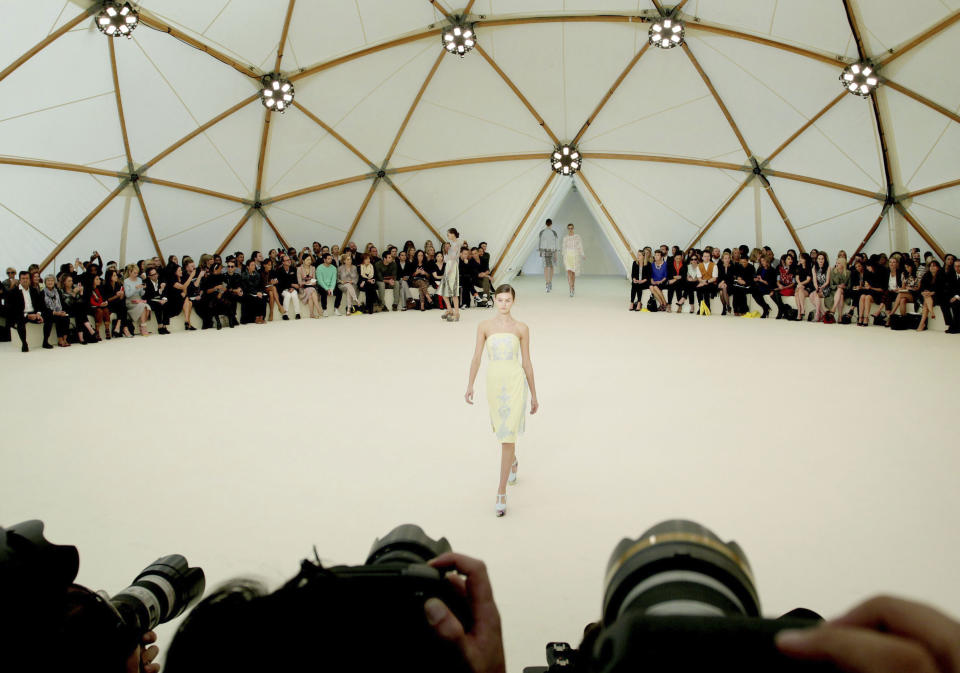 Models display designs during the Erdem Spring/Summer 2013 show in Manchester Square, London, on the fourth day of London Fashion Week, Monday, Sept. 17, 2012. (AP Photo/ Gareth Fuller/PA) UNITED KINGDOM OUT