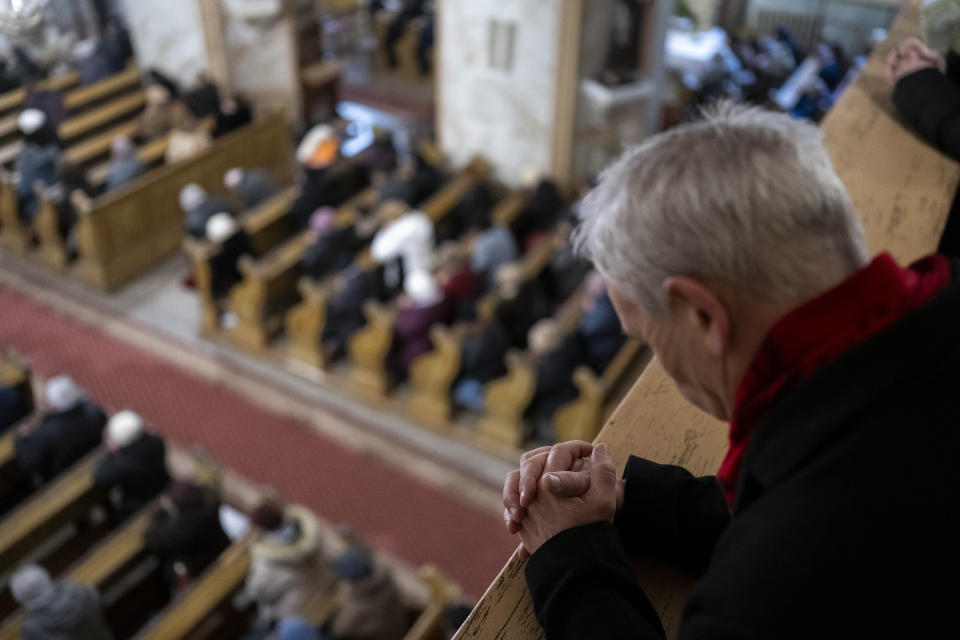 A member of Ukraine's ethnic Hungarian minority prays during a mass at a Catholic church in Uzhhorod on Sunday, Jan. 28, 2024. Ukraine amended its laws to comply with EU membership requirements, and restored many of the language rights for minorities demanded by Budapest but Hungary's government has indicated it is not fully satisfied — a potentially explosive sticking point as EU leaders meet Thursday, Feb. 1, 2024 to try and break Orban's veto of a major aid package earmarked for Kyiv. (AP Photo/Denes Erdos)