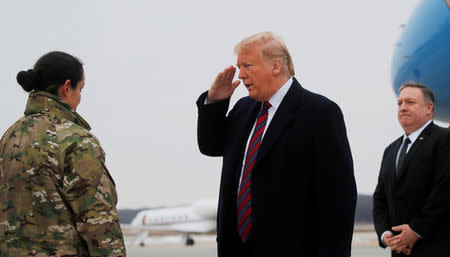 U.S. President Donald Trump salutes Chief Master Sergeant Danielle Hirvela, Chief Enlisted Manager of Air Force Mortuary Affairs Operations at Dover Air Force Base as he arrives with Secretary of State Mike Pompeo to attend the dignified transfer ceremonies for the remains of four U.S. military members and citizens killed during a recent attack in Syria that are now being returned to the United States, in Dover, Delaware, U.S., January 19, 2019. REUTERS/Carlos Barria