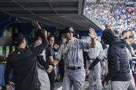 New York Yankees' DJ LeMahieu is congratulated after hitting a solo home run against the Toronto Blue Jays during the fifth inning of a baseball game Friday, June 17, 2022, in Toronto. (Christopher Katsarov/The Canadian Press via AP)