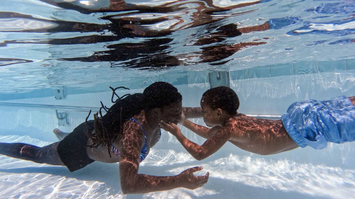 Cousins Mackenzie Riley, 12, and Zayzay Hamilton, 5, play underwater at A.D. Clark Pool on Wednesday, July 26, 2023, in Chapel Hill, N.C. Kaitlin McKeown/kmckeown@newsobserver.com