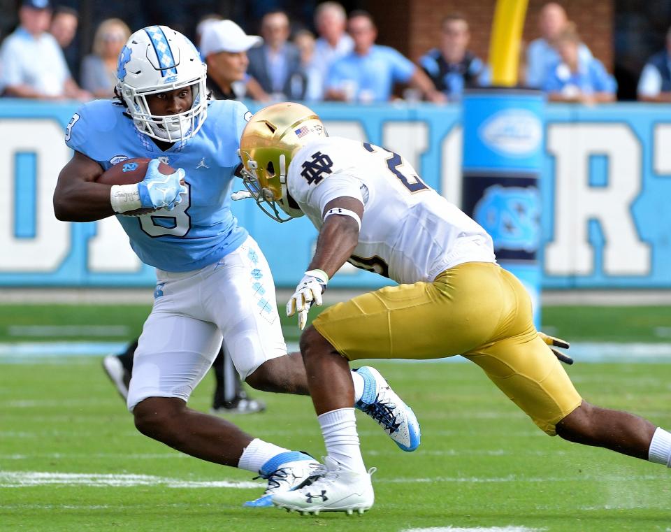 CHAPEL HILL, NC - OCTOBER 07: Michael Carter #8 of the North Carolina Tar Heels runs against Shaun Crawford #20 of the Notre Dame Fighting Irish during the game at Kenan Stadium on October 7, 2017 in Chapel Hill, North Carolina. (Photo by Grant Halverson/Getty Images)