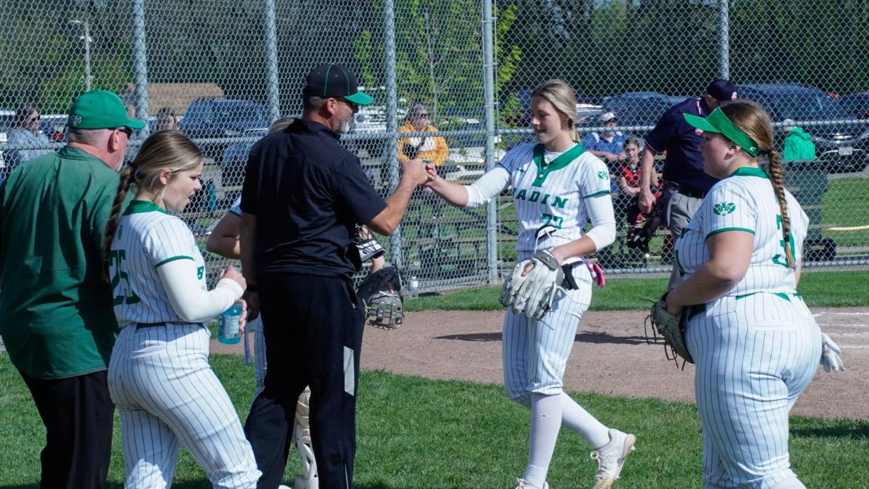 Badin's Halle Klaiber (23) fist bumps a Rams assistant coach after striking out three Mercy McAuley batters in the first inning on April 25, 2024 at Carl Schott Field in Hamilton, Oh.