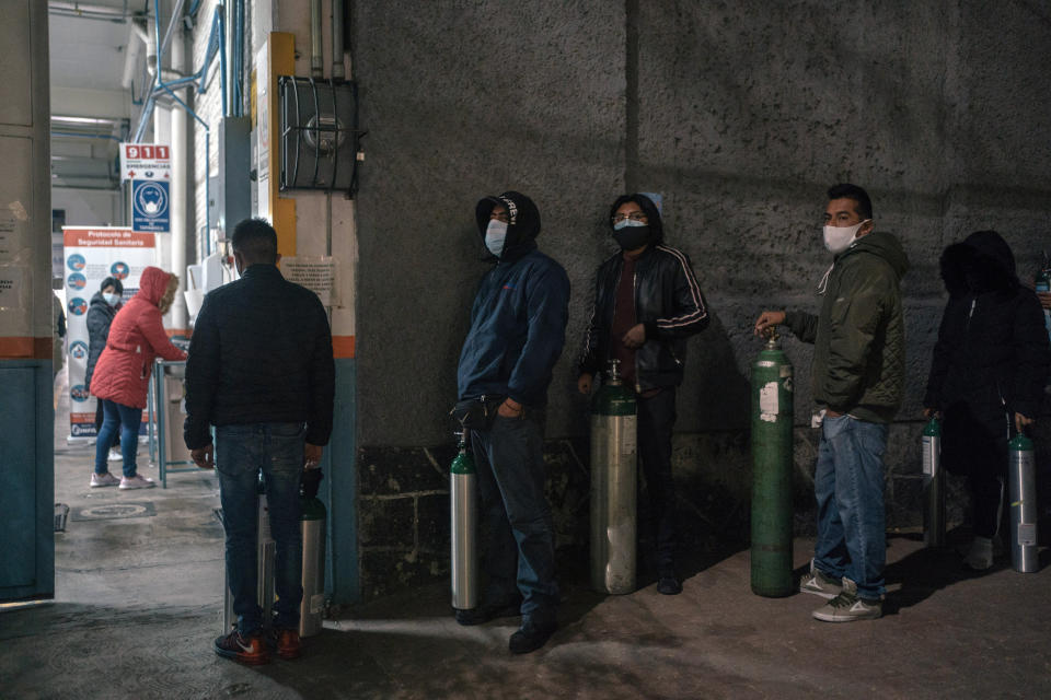 People line up to fill oxygen tanks at a government certified private provider in Mexico City on Wednesday, Feb. 3, 2021. With hospitals overrun, Mexicans fighting the coronavirus at home face a deadly hurdle: a lack of oxygen tanks. (Luis Antonio Rojas/The New York Times)                                                                                                                   