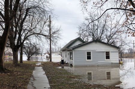 Homes sit in flood waters after leaving casualities and causing hundreds of millions of dollars in damages, with waters yet to crest in parts of the U.S. midwest, in Peru, Nebraska, U.S., March 19, 2019. REUTERS/Karen Dillon