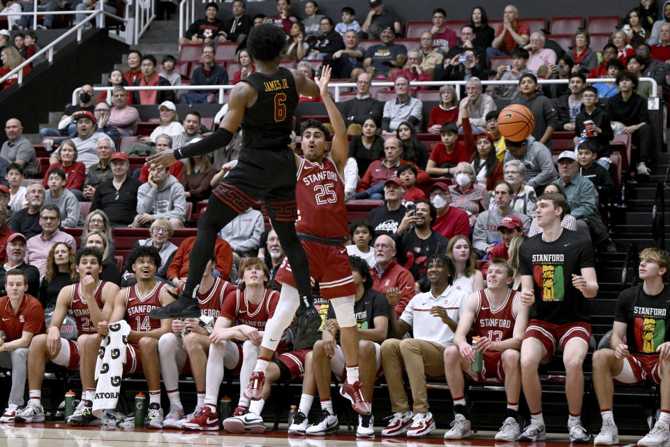 Southern California guard Bronny James (6) swats the ball away from Stanford guard Josue Gil-Silva (25) during the second half of an NCAA college basketball game Saturday, Feb. 10, 2024, in Stanford, Calif. (AP Photo/Nic Coury)