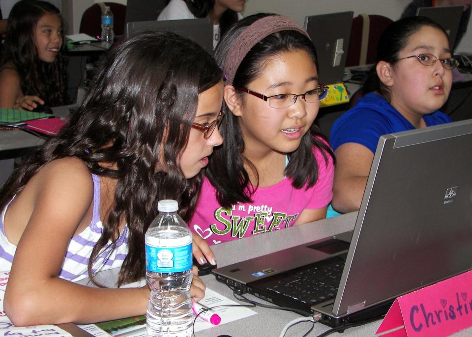 Middle school students work on creating a computer game during a camp designed to increase girls’ interest in computer science and related fields.