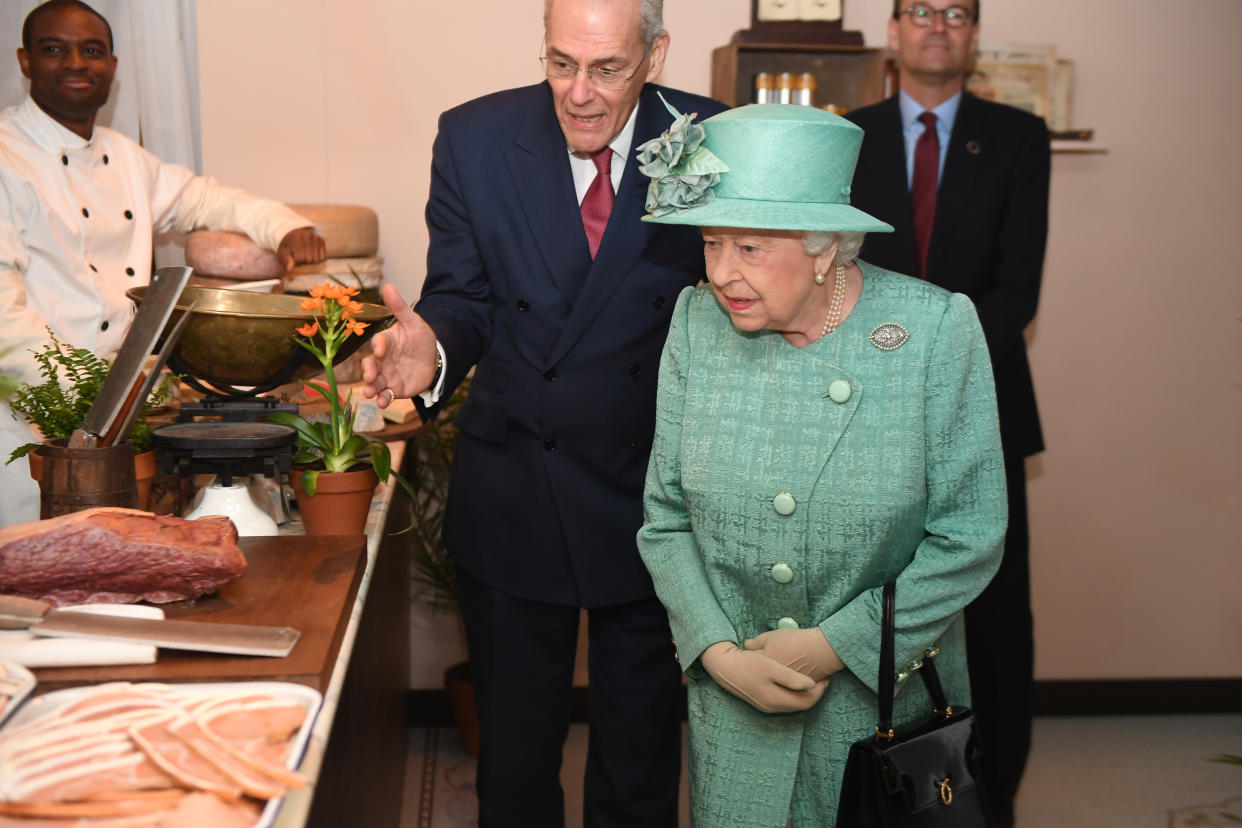 Queen Elizabeth II views goods on display in a replica of one of the original Sainsbury's stores during a visit to Covent Garden, London.