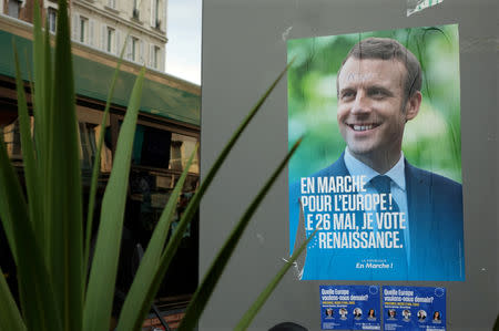 FILE PHOTO: An official European election poster of French President Emmanuel Macron is seen in Vincennes, France May 21, 2019. REUTERS/Charles Platiau/File Photo
