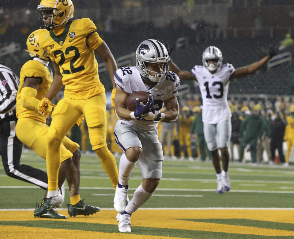 Kansas State running back Deuce Vaughn (22) score a touchdown past Baylor safety JT Woods (22) during the first half of an NCAA college football game Saturday, Nov. 28, 2020, in Waco, Texas. (Jerry Larson/Waco Tribune Herald via AP)