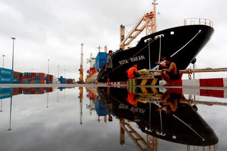 Workers chat near a ship at Asia World port in Yangon, Myanmar in this file photo from July 2, 2014. REUTERS/Soe Zeya Tun/Files