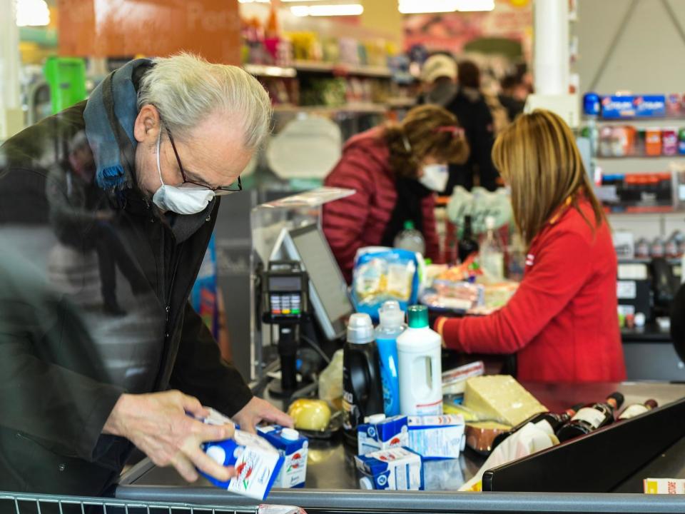 Residents wearing respiratory masks shop in a supermarket in small groups of 40 on 23 February 2020 in the Italian town of Casalpusterlengo amid the coronavirus outbreak: Getty Images