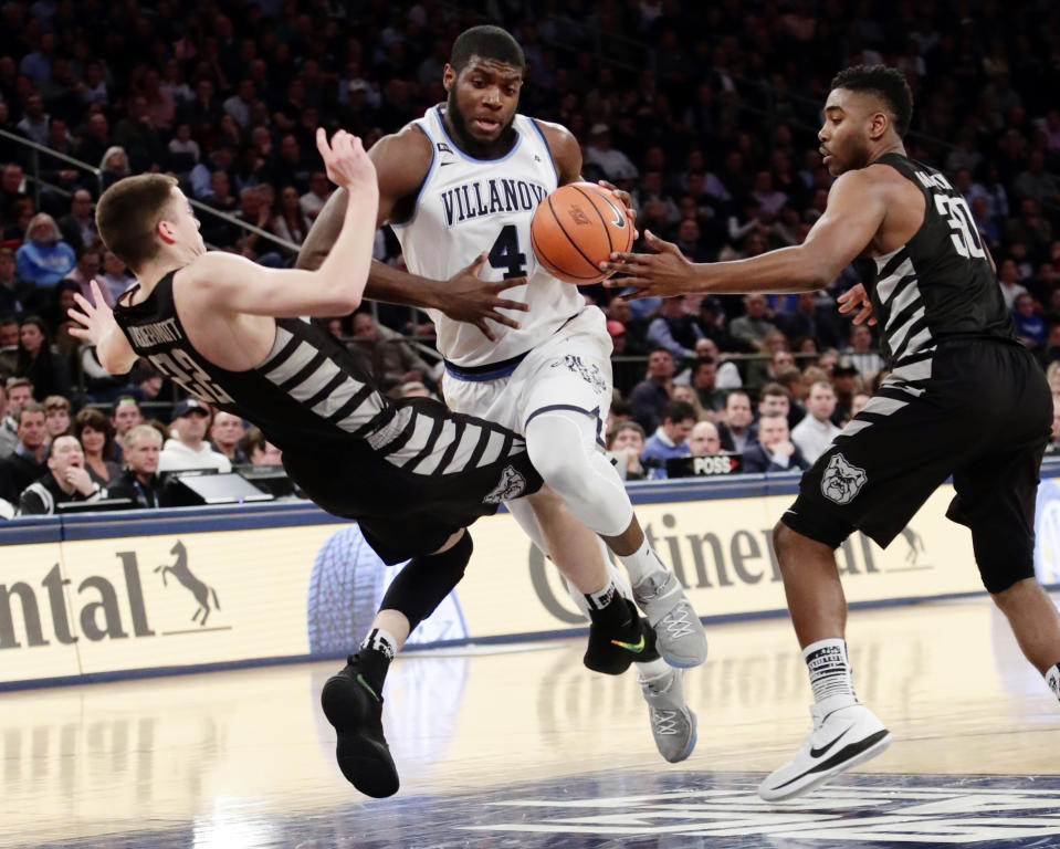 Villanova’s Eric Paschall (4) drives past Sean McDermott (22) and Kelan Martin (30) during the first half of an NCAA college basketball game in the Big East men’s tournament semifinals Friday, March 9, 2018, in New York. (AP Photo/Frank Franklin II)