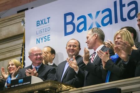 Ludwig Hantson (C), Chief Executive Officer of Baxalta, celebrates the company's IPO after ringing the opening bell above the floor of the New York Stock Exchange, July 1, 2015. REUTERS/Lucas Jackson