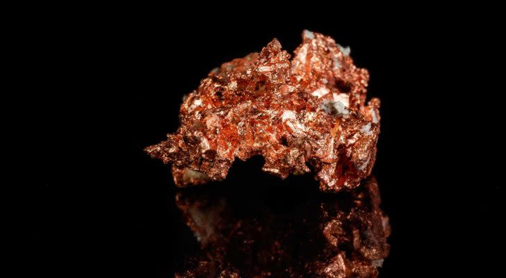 Piece of copper set against black background. Copper Stocks