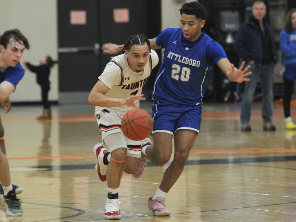 Taunton's Tyson Carter dribbles down court under pressure from Attleboro's Michael Beverly during an MIAA Division I Round of 32 game on March 3, 2023.