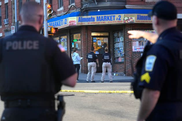 Law enforcement officials conduct an investigation at the scene of a fatal shooting Wednesday in Holyoke, Massachusetts. State police say at least three people, including a woman riding a bus, were shot.