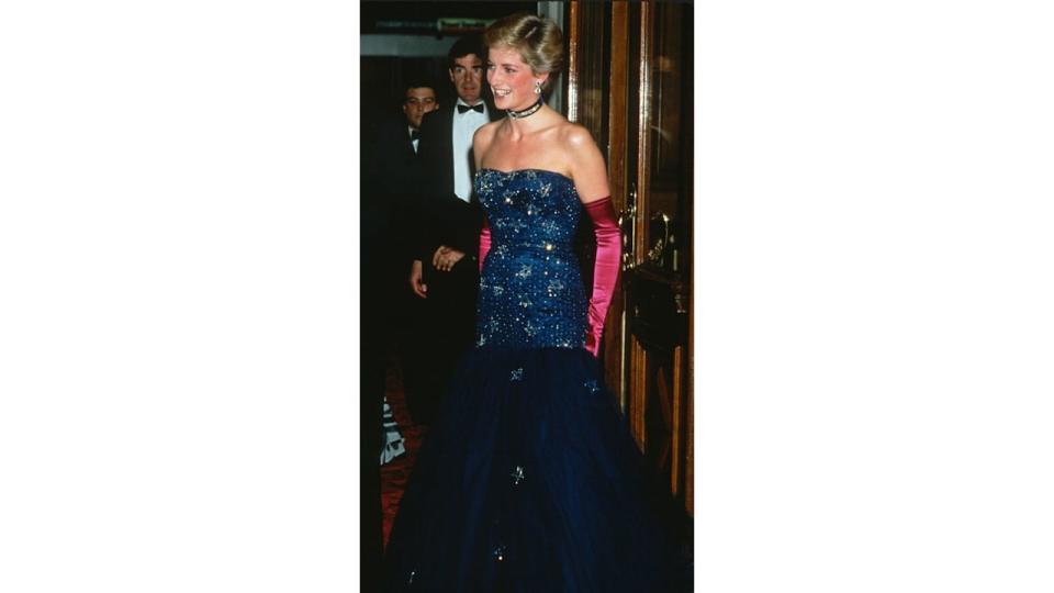 Diana, Princess of Wales, wearing a strapless blue dress designed by Murray Arbeid and long, pink gloves, attends the premiere of Andrew Lloyd Webber's 'Phantom of the Opera' at Her Majesty's Theatre on October 9, 1986