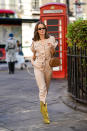 Therese Hellstrom is seen wearing a cream jumpsuit, accessorised with a brown crocodile print bag and statement yellow leopard print western boots. [Photo: Getty Images]