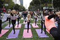 <p>Oakland Raiders and Houston Texans cheerleaders take part in a yoga class in front of the Angel of Independence monument Sunday, Nov. 20, 2016, in Mexico City. The Texans face the Raiders in an NFL football game in Mexico City Nov. 21. (AP Photo/Gregory Bull) </p>