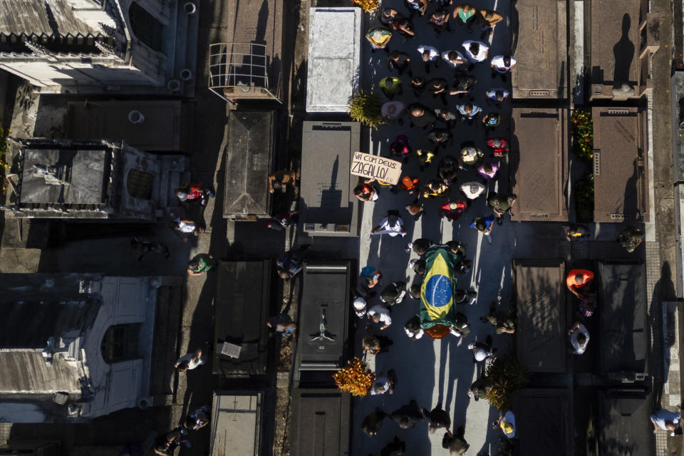 Mourners walk beside the coffin of former Brazilian soccer coach and player Mario Zagallo to attend the burial, at the São Joao Batista cemetery, in Rio de Janeiro, Brazil, Sunday, Jan. 7, 2024. Zagallo, who reached the World Cup final a record five times, winning four, as a player and then a coach with Brazil, died at the age of 92. (AP Photo/Bruna Prado)