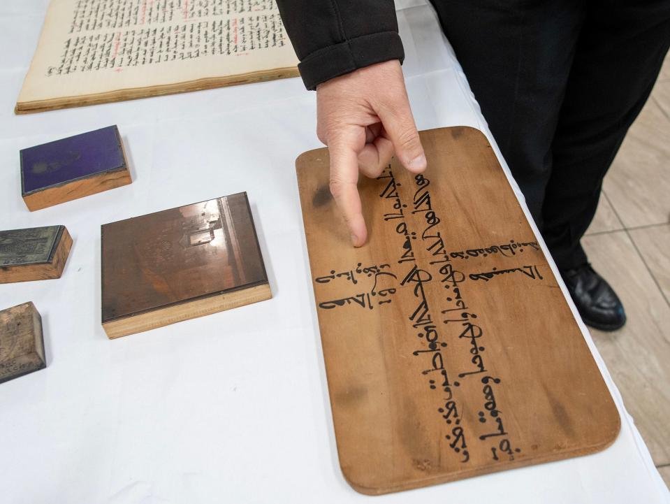 Fr. Toni Kasih reads the Aramaic inscription on the Table of Life used on the altar at St. Mary’s Syriac Orthodox Church of Shrewsbury. The item came from St. Mary’s Church in Jerusalem in 1926.