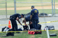 <p>Investigators search the bags that have been left behind at the Eugene Simpson Stadium Park where a shooting had happened June 14, 2017 in Alexandria, Va. (Photo: Alex Wong/Getty Images) </p>