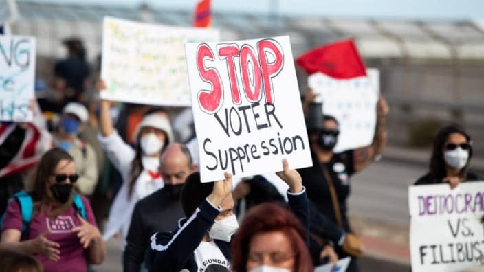 Marchers in Phoenix, Arizona, make their way across the 16th Street Bridge in an effort to bring awareness to voter suppression during the Deliver For Voting Rights rally in January. (Photo: Zac BonDurant/Special to The Arizona Republic/USA TODAY NETWORK)