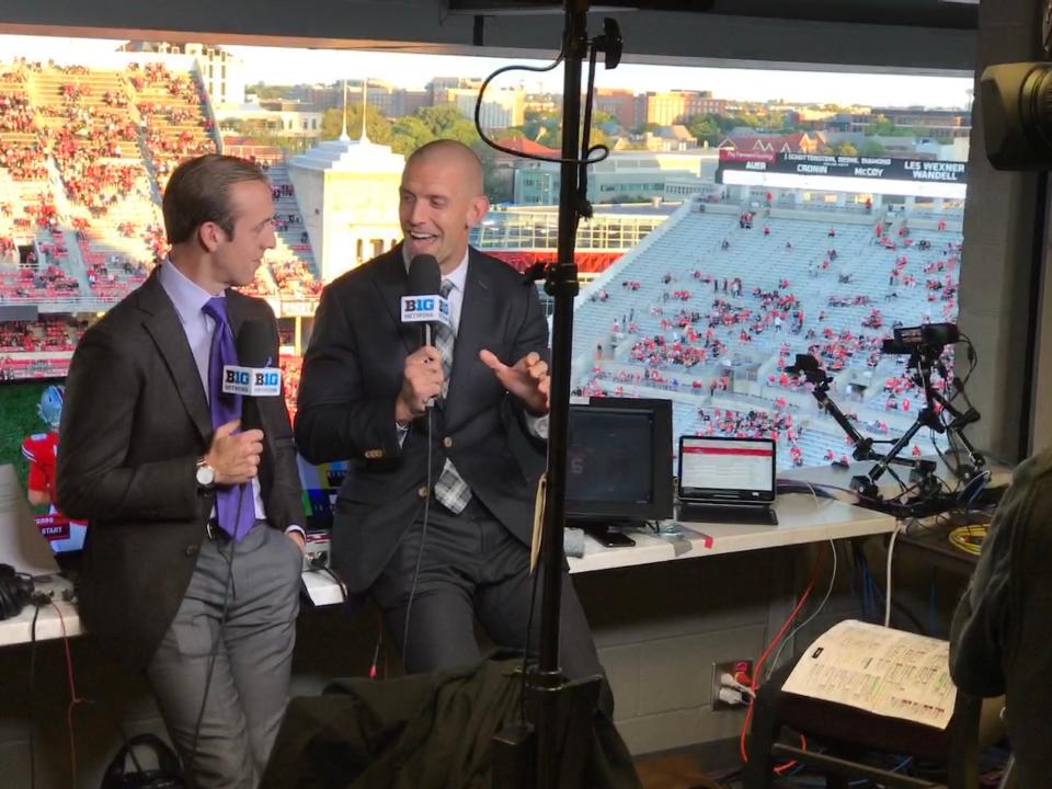 Brandon Gaudin (left) and James Laurinaitis talk in Ohio Stadium prior to the Ohio State versus Akron football game. They are on the Big Ten Network (BTN) crew. 