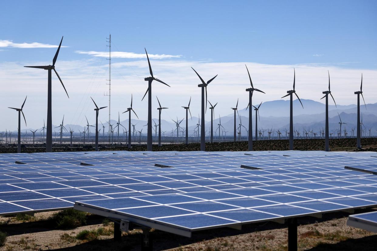 <span>Wind turbines operate at a wind farm near solar panels near Palm Springs, California, on 6 March 2024.</span><span>Photograph: Mario Tama/Getty Images</span>