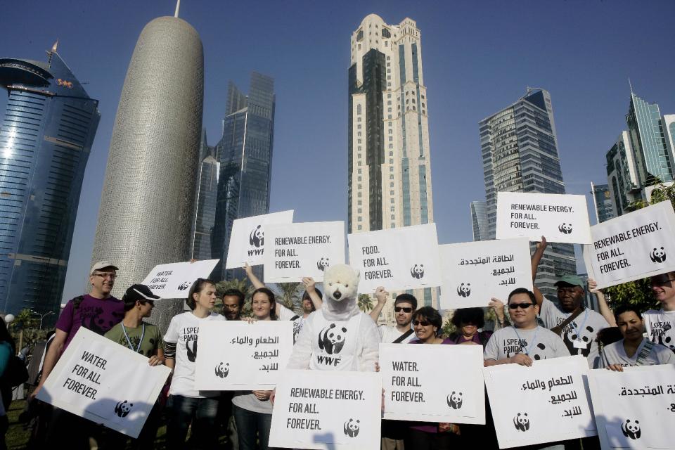 Local and international activists march to demand urgent action to address climate change at the U.N. climate talks in Doha, Qatar, Saturday , Dec. 1, 2012. (AP Photo/Osama Faisal)