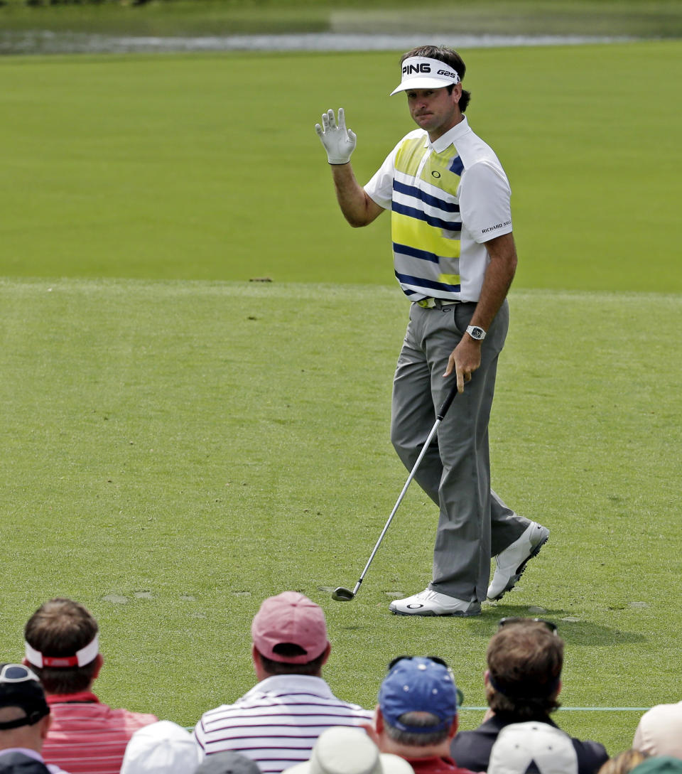 Bubba Watson waves to spectators after teeing off on the 12th role during the second round of the Masters golf tournament Friday, April 11, 2014, in Augusta, Ga. (AP Photo/Charlie Riedel)